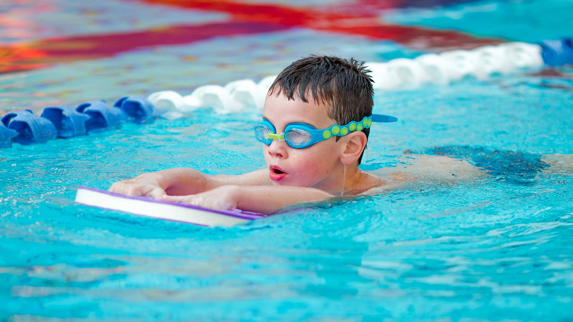 A child learning to swim during a swimming lesson in Benton Hall's swimming pool